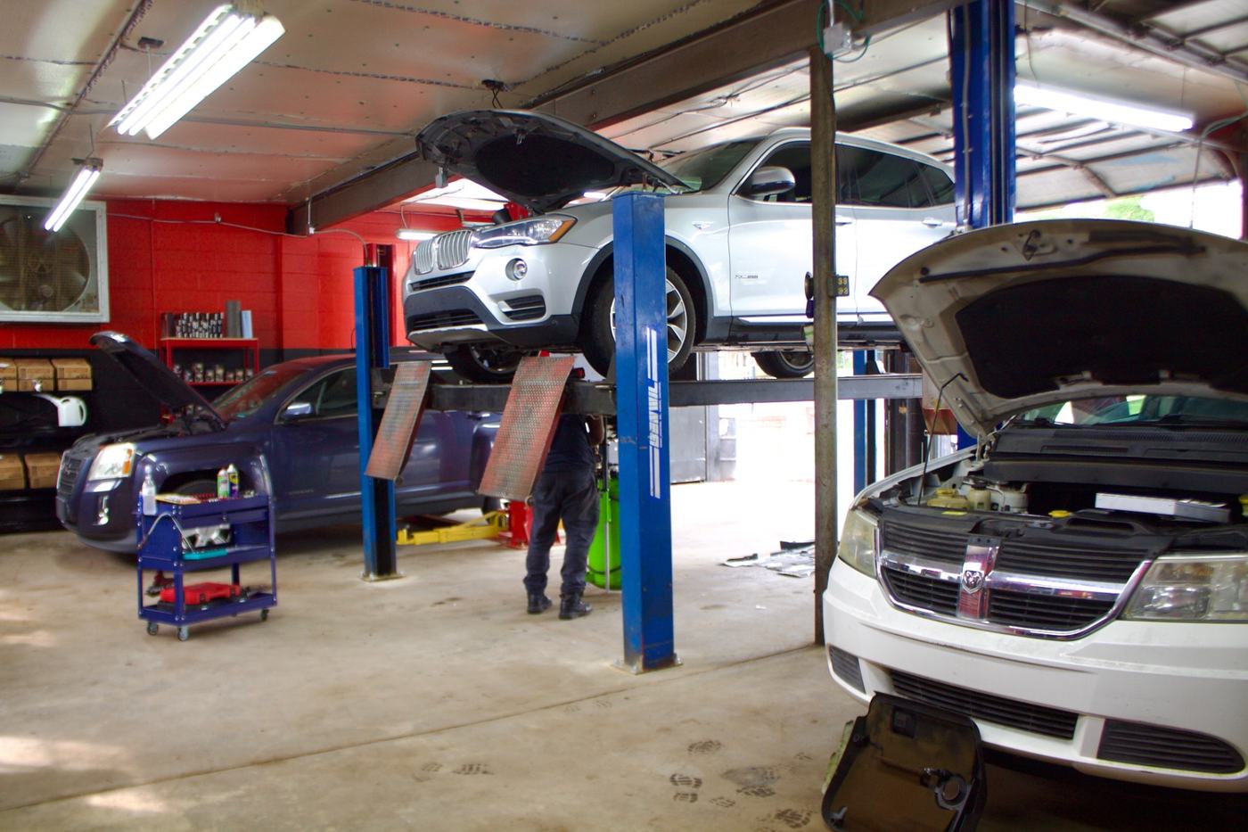 Vehicles on lifts inside the Auto Pro Services auto repair shop in Nashville, TN